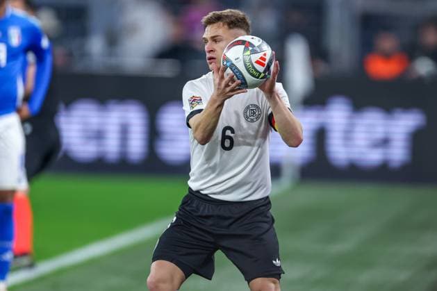 23 03 2025, Football, Quarter-final UEFA Nations League, Germany Italy, Signal Iduna Park, Season 2024 2025 Joshua Kimmich GER 06 gets the ball thrown to him by the ball kid DFB regulations prohibit any use of photographs as image sequences and or quasi video North Rhine-Westphalia Germany