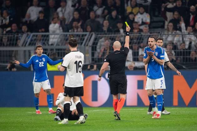 Referee Szymon MARCINIAK POL shows Riccardo CALAFIORI ITA the yellow card, warning Football UEFA Nations League Quarter-final, Round of 8, Germany GER Italy ITA 3 3 on 23 03 2024 at Signal Iduna Park Dortmund,