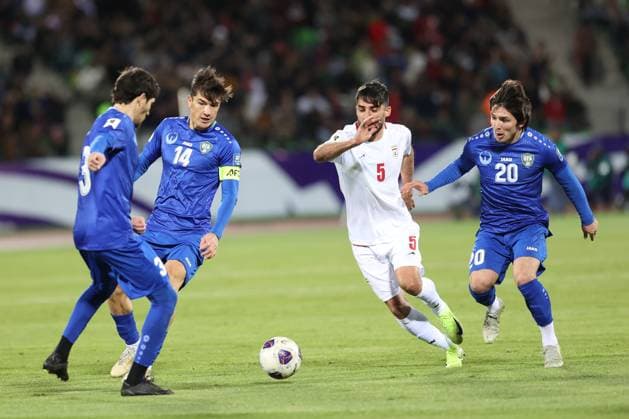 TEHRAN, IRAN - 25 March 2025 - Eldor Shomurodov of Uzbekistan and Milad Mohammadi of Iran, Khojimat Erkinov of Uzbekistan during the FIFA World Cup, WM, Weltmeisterschaft, Fussball 2026 Qualification AFC, Group A round 8 match between Iran and Uzbekistan at Azadi Stadium. Iran v Uzbekistan - FIFA World Cup 2026 Qualification national team, Nationalteam zone AFC, Group A, round 8 match. Copyright: xSFSIx2025x