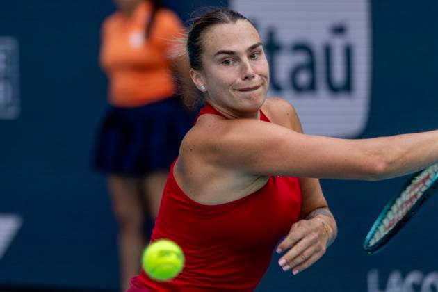 Aryna Sabalenka of Belarus hits a forehand during play against Jasmine Paolini of Italy in the first semifinal match on the stadium court at the Miami Open in the Hard Rock Stadium in Miami Gardens, Florida, on Thursday, March 27, 2025. Sabalenka defeated Paolini 6-2, 6-2.  MIA20250327107 GARYxIxROTHSTEIN