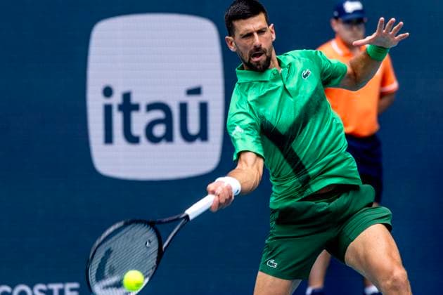 Novak Djokovic from Serbia hits a forehand shot to Grigor Dimitrov from Bulgaria in the first mens semifinal match on the stadium court at the Miami Open in the Hard Rock Stadium in Miami Gardens, Florida, on Friday, March 28, 2025. Djokovic defeated Dimitrov 6-2,6-3.  MIA20250328101 GARYxIxROTHSTEIN