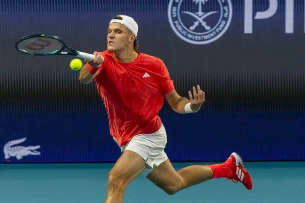 Jakub Mensik from Czech Republic hits a forehand shot to Taylor Fritz from the USA in the second mens semifinal match on the stadium court at the Miami Open in the Hard Rock Stadium in Miami Gardens, Florida, on Friday, March 28, 2025.  MIA20250328206 GARYxIxROTHSTEIN