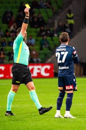 March 29, 2025, Cranbourne, Victoria, Australia: Match Official SHAUN EVANS shows a yellow card to Adelaide United FC Defender PANAGIOTIS KIKIANIS (51) during Round 24 of the Isuzu UTE A-League match between Melbourne Victory and Adelaide United at AAMI Park in Melbourne. Cranbourne Australia - ZUMAf186 20250329_zsp_f186_047 Copyright: xJamesxForresterx