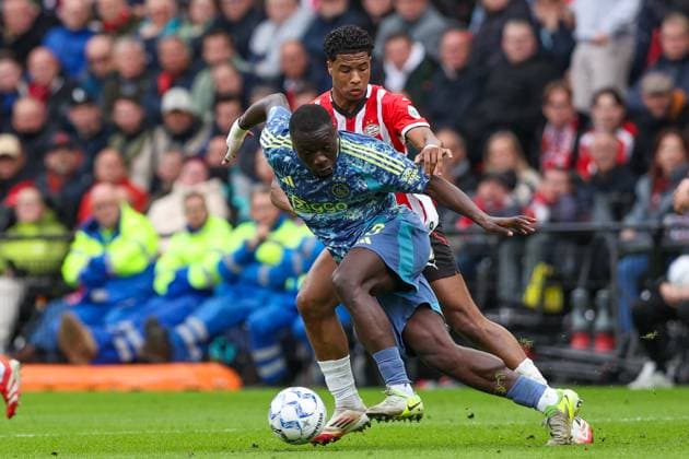 2025-03-30 PSV v AFC Ajax - Dutch Eredivisie EINDHOVEN, NETHERLANDS - MARCH 30: Brian Brobbey of AFC Ajax, Ryan Flamingo of PSV during the Dutch Eredivisie match between PSV and AFC Ajax at Philips Stadion on March 30, 2025 in Eindhoven, Netherlands. Eindhoven Philips Stadion Netherlands Content not available for redistribution in The Netherlands directly or indirectly through any third parties. Copyright: xBenxGalx