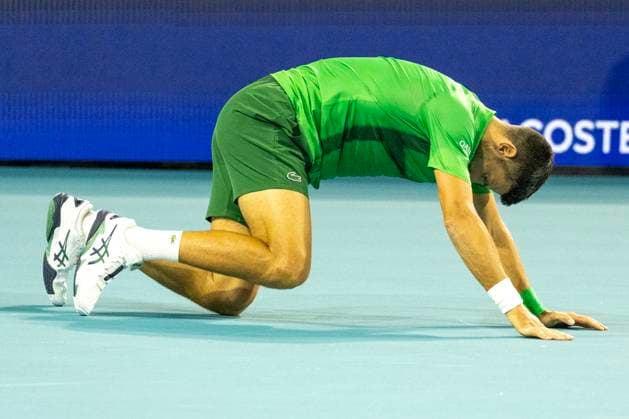 Novak Djokovic from Serbia slipped and fell on the court during a return shot to Jakub Mensik from the Czachia in the men s championship match on the stadium court at the Miami Open in the Hard Rock Stadium in Miami Gardens, Florida, on Sunday, March 30, 2025. Mensik defeated Djokovic 7-6 (4), 7-6(4).  MIA20250330117 GARYxIxROTHSTEIN