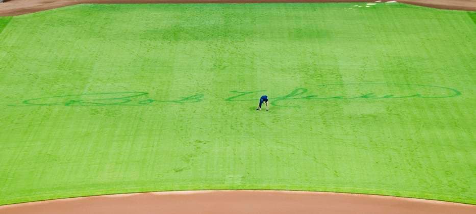 A grounds keeper walks on the field by the signature of Milwaukee Brewers catcher and broadcast announcer Bob Uecker before the start of the MLB, Baseball Herren, USA baseball game between the Kansas City Royals and the Milwaukee Brewers at American Family Field in Milwaukee, Wisconsin on Monday, March 31, 2025. Uecker died at age 90 on January 16, 2025 at his home in Menomonee Falls, Wisconsin. The game is the Brewers 2025 season home opener. The game is the Brewers 2025 season home opener.  MIL20250331803 TANNENxMAURY