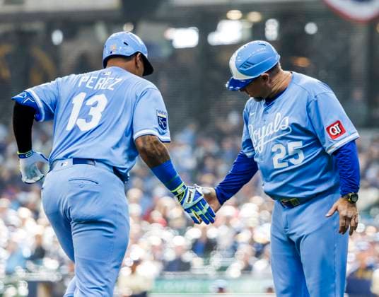 Kansas City Royals catcher Salvador Perez (L) celebrates with Kansas City Royals third base coach Vance Wilson (R) after hitting a solo home run in the seventh inning of the MLB, Baseball Herren, USA baseball game between the Kansas City Royals and the Milwaukee Brewers at American Family Field in Milwaukee, Wisconsin on Monday, March 31, 2025. The game is the Brewers 2025 season home opener.  MIL20250331826 TANNENxMAURY