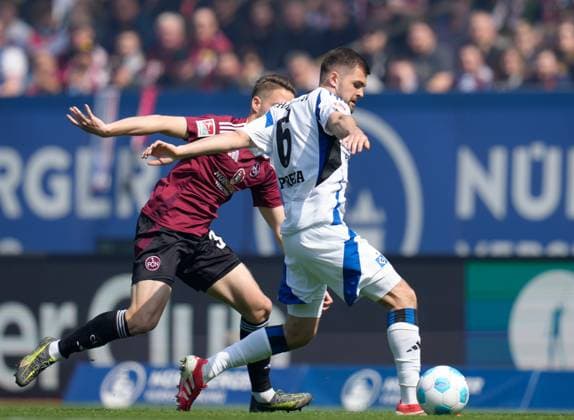 Lukasz Poreba Hamburger SV, 6 vs Lukas Schleimer 1 FC Nuernberg, 36 GER, 1 FC Nuernberg vs Hamburger SV, 2 Bundesliga, 28 Matchday, Season 2024 2025, 05 04 2025 DFL REGULATIONS PROHIBIT ANY USE OF PHOTOGRAPHS AS IMAGE SEQUENCES AND OR QUASI VIDEO GER, 1 FC Nuernberg vs Hamburger SV, 2 Bundesliga, 28 Matchday, Season 2024 2025, 05 04 2025 Nuernberg Copyright: xEibner-Pressefoto ScottxColemanx EP_SCN