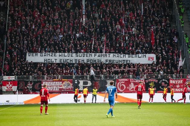 The fans of 1 FC Kaiserslautern hold up a banner with the inscription Der ganze wilde Südenfährt nach Berlin, holt euch den Pokal Freunde 2 Fußball Bundesliga Saison 2024 2025 1 FC Magdeburg vs 1 FC Kaiserslautern at the Avnet Arena in Magdeburg Action,Football,Man,Men,Germany,06 04 2025