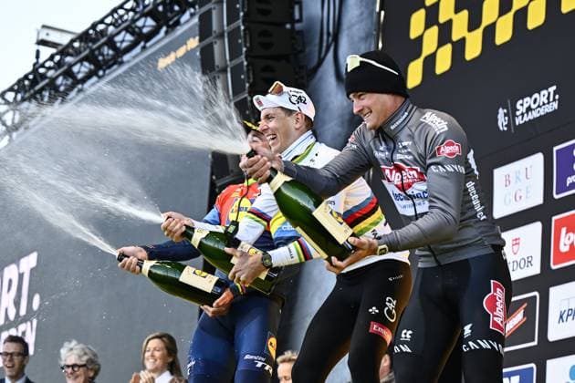 Slovenian Tadej Pogacar of UAE Team Emirates celebrates on the podium with champagne after winning the men s race of the Ronde van Vlaanderen Tour des Flandres Tour of Flanders one day cycling race, 268,9km from Brugge to Oudenaarde, Sunday 06 April 2025. ERICxLALMAND  x119657940x