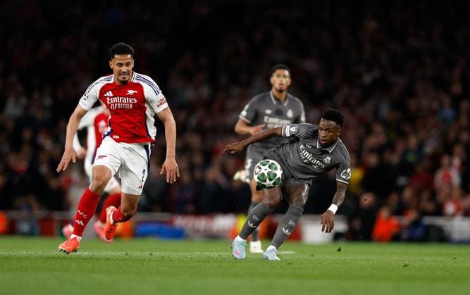 Vinicius Junior of Real Madrid plays the ball watched by William Saliba of Arsenal Arsenal v Real Madrid, Football, UEFA Champions League, Emirates Stadium, Islington, London, UK - 08 04 2025 Editorial use only  Copyright: xMattxImpey Shutterstockx 15244749y