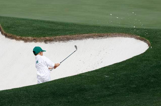 Byeong-hun An s son tries to shoot out of a sand bunker during the 2025 Masters Par 3 Contest at Augusta National Golf Club in Augusta, Georgia, on Wednesday, April 9, 2025. The 2025 Masters Golf tournament begins on Thursday, April 10.  AUG20250409852 JOHNxANGELILLO
