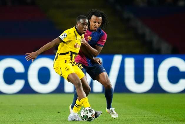 FC Barcelona, Barca v Borussia Dortmund - UEFA Champions League 2024 25 Quarter Final First Leg Jamie Gittens left winger of Borussia Dortmund and England and Jules Kounde centre-back of Barcelona and France compete for the ball during the UEFA Champions League 2024 25 Quarter Final First Leg match between FC Barcelona and Borussia Dortmund at Estadi Olimpic Lluis Companys on April 9, 2025 in Barcelona, Spain. Barcelona Spain  Copyright: xJosexBretonx originalFilename:bretonhernandez-fcbarcel250409_npPom.jpg