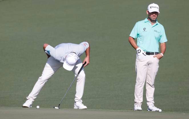 Stephan Jaeger of Germany looks at his ball next to Brian Harman on the second hole during the first round of the Masters golf tournament at Augusta National Golf Club in Augusta, Georgia on Thursday, April 10, 2025.  AUG20250410519 TANNENxMAURY