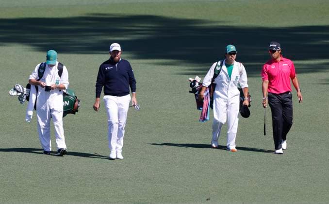 Shane Lowry of Ireland and Hideki Matsuyama of Japan walk down the fairway on the second hole during round two of the 2025 Masters golf tournament at Augusta National Golf Club in Augusta, Georgia, on Friday, April 11, 2025.  AUG20250411515 TANNENxMAURY