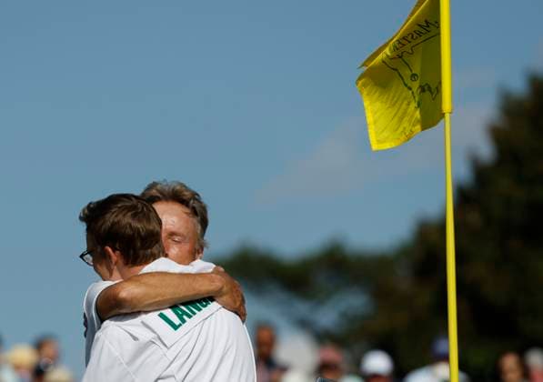 Bernhard Langer of Germany hugs his son and caddie Jason on the 18th green during the second round of the 2025 Masters golf tournament at Augusta National Golf Club in Augusta, Georgia, on Friday, April 11, 2025. Langer a two-time winner of the green jacket in 1985 and 1993 had announced that his 41st Masters appearance will be his last. Langer missed the cut making a bogey on the 18th hole.  AUG202504112004 JOHNxANGELILLO