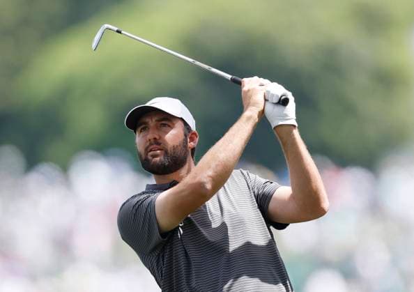 Scottie Scheffler hits his approach shot to the 1st hole during the third round of the 2025 Masters golf tournament at Augusta National Golf Club in Augusta, Georgia, on Saturday, April 12, 2025.  AUG20250412519 JOHNxANGELILLO