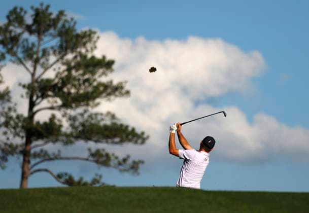 Justin Rose of England hits his approach shot on the 17th hole during the third round of the 2025 Masters golf tournament at Augusta National Golf Club in Augusta, Georgia, on Saturday, April 12, 2025.  AUG20250412587 JOHNxANGELILLO