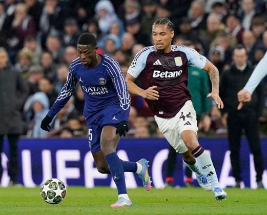 Birmingham, England, 15th April 2025. Nuno Mendes of Paris St Germain and Aston Villa s Boubacar Kamara during the Aston Villa vs Paris Saint Germain Quarter Final 2nd Leg UEFA Champions League match at Villa Park, Birmingham. Picture credit should read: Andrew Yates Sportimage EDITORIAL USE ONLY. No use with unauthorised audio, video, data, fixture lists, club league logos or live services. Online in-match use limited to 120 images, no video emulation. No use in betting, games or single club league player publications. SPI_045_AY_Villa_PSG SPI-3842-0045