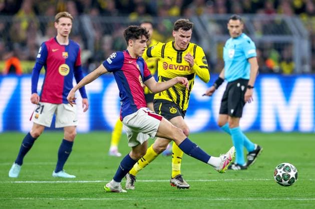 15 04 2025, Football, UEFA Champions League, Borussia Dortmund FC Barcelona, BVB Stadion, Quarter-final, Season 2024 2025 Gerard Martin FC Barcelona 35 in duel against Pascal Groß BVB 13 Regulations prohibit any use of photographs as image sequences and or quasi video Nordrhein Westfalen Germany