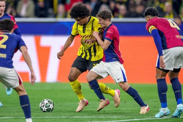 15 04 2025, Football, UEFA Champions League, Borussia Dortmund FC Barcelona, BVB Stadion, Quarter-final, Season 2024 2025 Karim Adeyemi BVB 27 in duel against Pablo Torre FC Barcelona 14 Regulations prohibit any use of photographs as image sequences and or quasi video Nordrhein Westfalen Germany