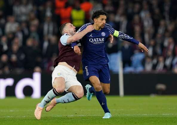 Birmingham, England, 15th April 2025. Aston Villa s John McGinn (l) is elbowed in the face by Marquinhos of Paris St Germain during the Aston Villa vs Paris Saint Germain Quarter Final 2nd Leg UEFA Champions League match at Villa Park, Birmingham. Picture credit should read: Andrew Yates Sportimage EDITORIAL USE ONLY. No use with unauthorised audio, video, data, fixture lists, club league logos or live services. Online in-match use limited to 120 images, no video emulation. No use in betting, games or single club league player publications. SPI_066_AY_Villa_PSG SPI-3842-0066