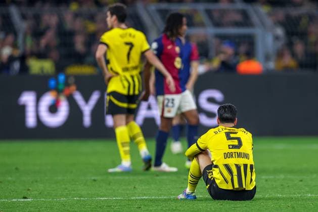 15 04 2025, Football, UEFA Champions League, Borussia Dortmund FC Barcelona, BVB Stadion, Quarter-finals, 2024 2025 season Disappointment after elimination from the Champions League BVB is eliminated from the UCL despite a 3 1 win Ramy Bensebaini BVB 5 sits disappointed on the pitch Disappointment Regulations prohibit any use of photographs as image sequences and or quasi video Nordrhein Westfalen Germany