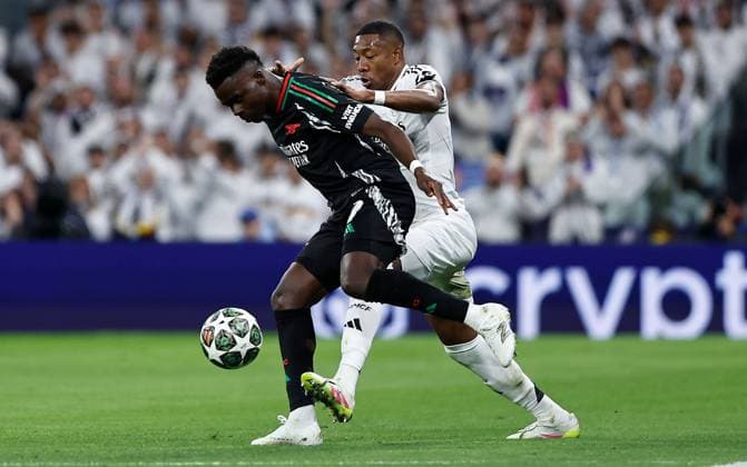 Bukayo Saka of Arsenal and David Alaba of Real Madrid in action Real Madrid v Arsenal, UEFA Champions League, Quarter-Finals, 2nd Leg, Football, Santiago Bernabu Stadium, Madrid, Spain - 16 Apr 2025 EDITORIAL USE ONLY No use with unauthorised audio, video, data, fixture lists, club league logos or live services. Online in-match use limited to 120 images, no video emulation. No use in betting, games or single club league player publications. Copyright: xRubenxAlbarran Shutterstockx 15253938ak