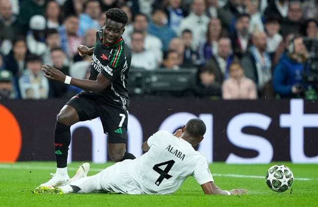 Bukayo Saka of Arsenal is fouled by David Alaba of Real Madrid Real Madrid v Arsenal, UEFA Champions League, Quarter-Finals, 2nd Leg, Football, Santiago Bernabu Stadium, Madrid, Spain - 16 Apr 2025 EDITORIAL USE ONLY No use with unauthorised audio, video, data, fixture lists, club league logos or live services. Online in-match use limited to 120 images, no video emulation. No use in betting, games or single club league player publications.  Copyright: xGokhanxTaner Shutterstockx 15253937v
