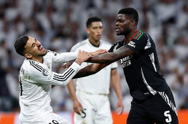 Thomas Partey of Arsenal fouls Dani Ceballos of Real Madrid to earn a yellow card ruling him out of the first leg of a potential semi final vs PSG Real Madrid v Arsenal, UEFA Champions League, Quarter-Finals, 2nd Leg, Football, Santiago Bernabu Stadium, Madrid, Spain - 16 Apr 2025 EDITORIAL USE ONLY No use with unauthorised audio, video, data, fixture lists, club league logos or live services. Online in-match use limited to 120 images, no video emulation. No use in betting, games or single club league player publications. Copyright: xRubenxAlbarran Shutterstockx 15253938cw