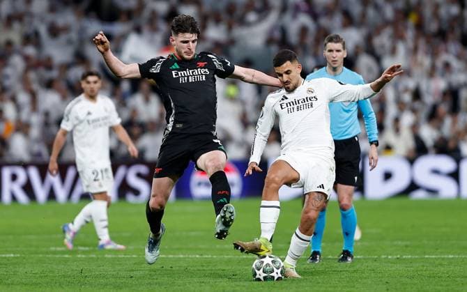 Declan Rice of Arsenal and Dani Ceballos of Real Madrid in action Real Madrid v Arsenal, UEFA Champions League, Quarter-Finals, 2nd Leg, Football, Santiago Bernabu Stadium, Madrid, Spain - 16 Apr 2025 EDITORIAL USE ONLY No use with unauthorised audio, video, data, fixture lists, club league logos or live services. Online in-match use limited to 120 images, no video emulation. No use in betting, games or single club league player publications. Copyright: xRubenxAlbarran Shutterstockx 15253938da