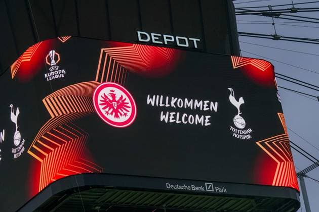 Football UEFA Europa League 2024 2025, quarter-final second leg Eintracht Frankfurt vs Tottenham Hotspur Deutsche Bank Park Frankfurt scoreboard with welcome Welcome, logos of Eintracht Frankfurt and Tottenham Hotspur, UEFA Europa League logo, modern graphics with red and orange lines, Depot lettering above the board, stadium roof and rope hoists in the background Copyright: xJOERANxSTEINSIEKx