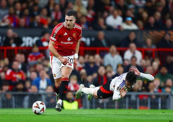 Diogo Dalot of Manchester United, ManU and Nicolas Tagliafico of Lyon Manchester United v Olympique Lyonnais, UEFA Europa League, Quarter Final, Second Leg, Football, Old Trafford, Manchester, UK - 17 Apr 2025 EDITORIAL USE ONLY No use with unauthorised audio, video, data, fixture lists, club league logos or live services. Online in-match use limited to 120 images, no video emulation. No use in betting, games or single club league player publications.  Copyright: xMattxWest Shutterstockx 15253946ak