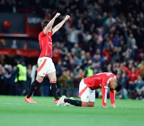 17th April 2025; Old Trafford, Manchester, England; Europa League Quarter Final Second Leg Football, Manchester United, ManU versus Lyon; Harry Maguire of Manchester United salutes the crowd and Casemiro drops to his knees after their last minute 5-4 win  ActionPlus12775773 RogerxEvans