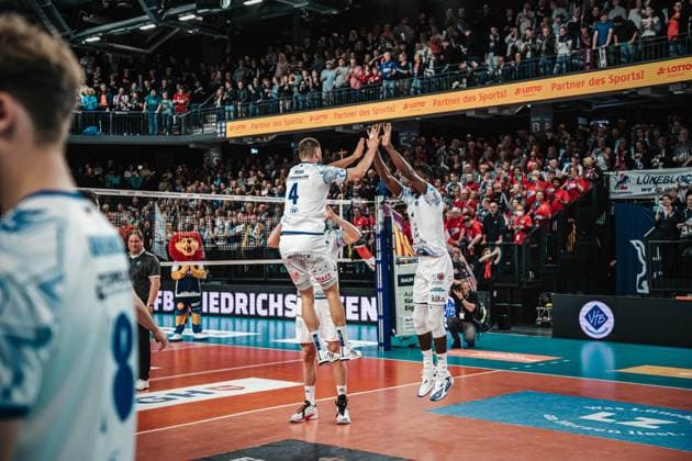 Volleyball mens season 2024 2025 Volleyball Bundesliga playoff semi-final match 5 SVG Lüneburg vs VfB Friedrichshafen 19 04 2025 Tim Peter 4 VfB Friedrichshafen and Jose Israel Masso Alvarez 1 VfB Friedrichshafen jump to high-five as they enter the LKH Arena Lüneburg LKH Arena Niedersachsen Germany