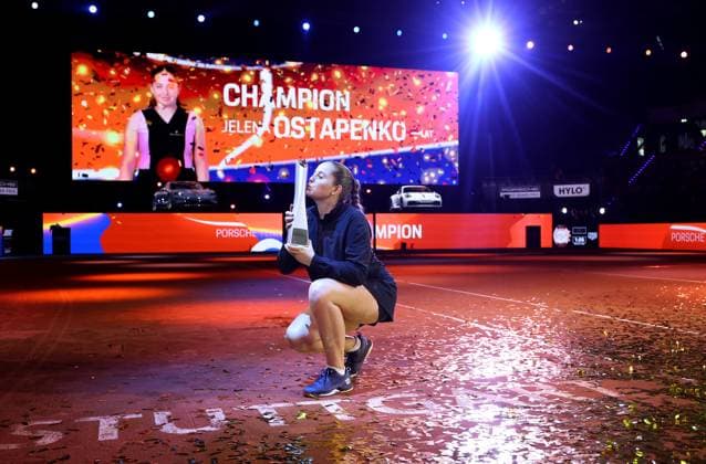 Stuttgart , Porsche Tennis Grand Prix Final, winner Jelena Ostapenko LAT kisses her trophy in front of the winning car Macan Turbo