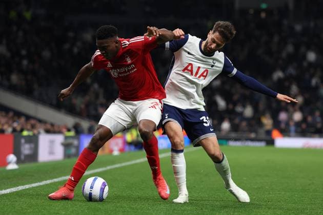 London, England, 21st April 2025. Taiwo Awoniyi of Nottingham Forest and Rodrigo Bentancur of Tottenham Hotspur challenge for the ball during the Tottenham Hotspur vs Nottingham Forest Premier League match at the Tottenham Hotspur Stadium, London. Picture credit should read: Paul Terry Sportimage EDITORIAL USE ONLY. No use with unauthorised audio, video, data, fixture lists, club league logos or live services. Online in-match use limited to 120 images, no video emulation. No use in betting, games or single club league player publications. SPI_121_PT_Tottenham_Notts_Forest SPI-3856-0121