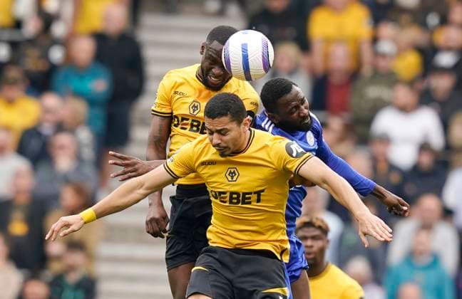 Wolverhampton, England, 26th April 2025. Toti Gomes of Wolverhampton Wanderers (C) heads clear from Andre of Wolverhampton Wanderers and Wilfred Ndidi of Leicester City during the Wolverhampton Wanderers vs Leicester City Premier League match at Molineux, Wolverhampton. Picture credit should read: Andrew Yates Sportimage EDITORIAL USE ONLY. No use with unauthorised audio, video, data, fixture lists, club league logos or live services. Online in-match use limited to 120 images, no video emulation. No use in betting, games or single club league player publications. SPI_001_AY_WOLVES_LEICESTER SPI-3887-0001