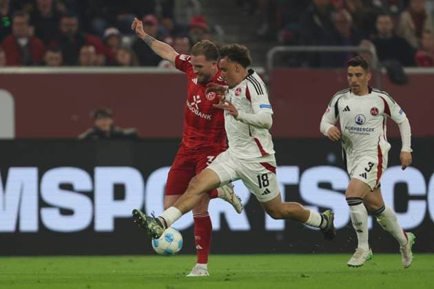 Andre Hoffmann Fortuna Duesseldorf and Rafael Lubach 1 FC Nuremberg battle for the ball during the 2 Bundesliga match between Fortuna Duesseldorf and 1 FC Nuremberg at Merkur Spiel Arena on April 26, 2025 in Duesseldorf, Germany, Germany Photo by Oliver Kaelke DeFodi Images Andre Hoffmann Fortuna Duesseldorf and Rafael Lubach 1 FC Nürnberg battle for the ball during the 2 Bundesliga match between Fortuna Düsseldorf and 1 FC Nürnberg at Merkur Spiel Arena on April 26, 2025 in Düsseldorf, Germany Photo by Oliver Kaelke DeFodi Images DFB DFL REGULATIONS PROHIBIT ANY USE OF PHOTOGRAPHS AS IMAGE SEQUENCES AND OR QUASI VIDEO Photo by Oliver Kaelke DeFodi Images