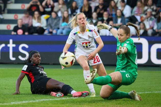 Cologne, Germany 27 April 2025 1 BL Women 2024 2025 1 FC Köln vs Eintracht Frankfurt In the picture from left the third goalkeeper Aurora Mikalsen 1 FC Köln defends a ball from Nicole Anyomi Eintracht Frankfurt and prevents a goal for Frankfurt DFB regulations prohibit any use of photographs as image sequences and or quasi video Rhein Energie Stadion Nordrhein Westfalen Copyright: xFotostandx xFantinix
