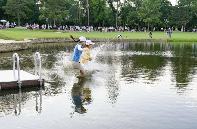 Golf: Chevron Championship Japanese golfer Mao Saigo (R) jumps into the pond after winning the Chevron Championship in a five-way playoff at The Club at Carlton Woods in The Woodlands, Texas, on April 27, 2025.  A14AA0004501106P