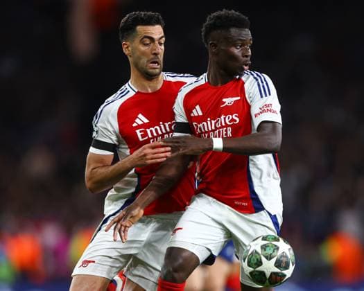 Mikel Merino of Arsenal (L) and Bukayo Saka of Arsenal (R) battles for the same ball Arsenal v Paris Saint-Germain, UEFA Champions League, Semi Final, First Leg, Football, Emirates Stadium, London, UK - 29 Apr 2025 EDITORIAL USE ONLY No use with unauthorised audio, video, data, fixture lists, club league logos or live services. Online in-match use limited to 120 images, no video emulation. No use in betting, games or single club league player publications. Copyright: xKieranxMcManus Shutterstockx 15275544dm