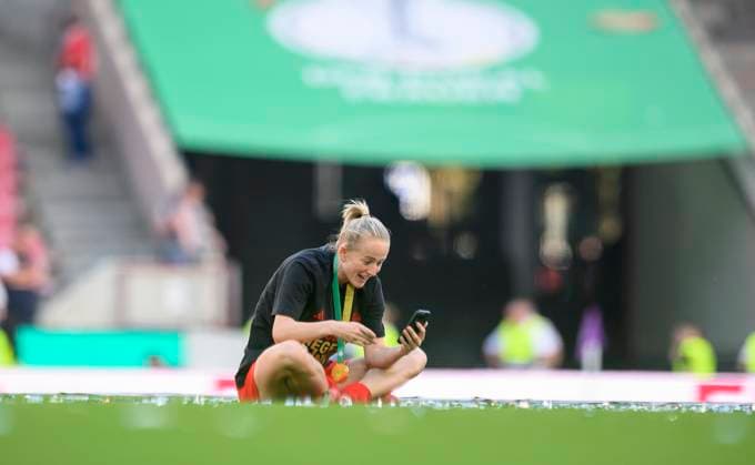 Lea SCHUELLER Schüller M sits on the court with her cell phone and talks after the award ceremony, DFB Pokal Final Women 2025, FC Bayern Muenchen M SV Werder Bremen HB , on 01 05 2025 in Koeln Germany DFB regulations prohibit any use of photographs as image sequences and or quasi video Â