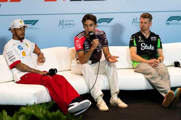 British Formula One driver George Russell of Mercedes-AMG Petronas, center, speaks during the Formula One Miami Grand Prix at the Miami International Autodrome in Miami Gardens, Florida on Thursday, May 1, 2025.  MIA2025050122 GREGxNASH