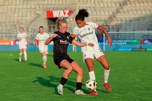 Julie Terlinden SGS Essen and Cora Zicai SC Freiburg battle for the ball, Google Pixel Frauen Bundesliga, SGS Essen vs SC Freiburg, Stadion an der Hafenstrasse, May 2, 2025 in Essen, Germany Photo by Marco Steinbrenner DeFodi Images Julie Terlinden SGS Essen and Cora Zicai SC Freiburg battle for the ball, Google Pixel Womens Bundesliga, SGS Essen vs SC Freiburg, Stadion an der Hafenstrasse, May 2, 2025 in Essen, Germany Photo by Marco Steinbrenner DeFodi Images DFB DFL REGULATIONS PROHIBIT ANY USE OF PHOTOGRAPHS AS IMAGE SEQUENCES AND OR QUASI VIDEO