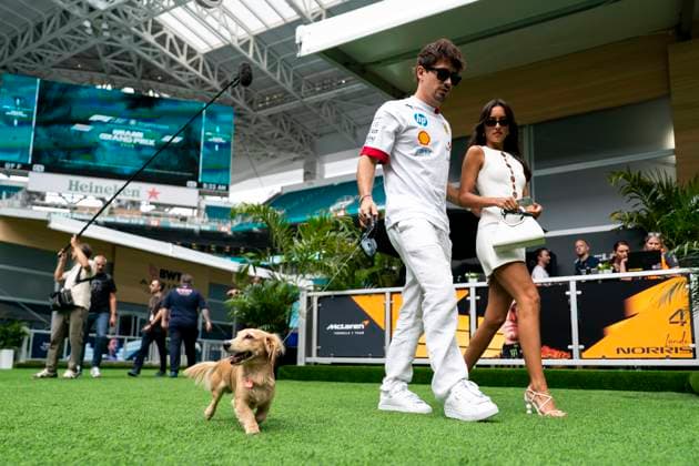 Monaco s Formula One driver Charles Leclerc of Scuderia Ferrari and Alexandra Saint Mleux accompanied by Leclerc s dog Leo arrive during the Formula One Miami Grand Prix at the Miami International Autodrome in Miami Gardens, Florida on Saturday, May 3, 2025.  MIA2025050309a GREGxNASH