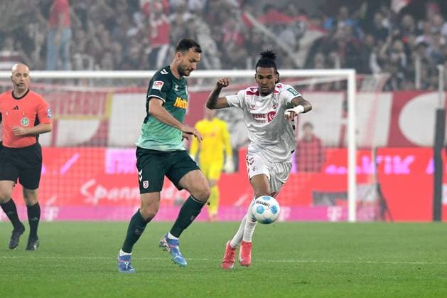Florian Ballas Jahn Regensburg and Damion Downs 1 FC Koeln battle for the ball during the 2 Bundesliga match between 1 FC Köln and Jahn Regensburg at RheinEnergieStadion on May 03, 2025 in Cologne, Germany, Germany Photo by Ralf Treese DeFodi Images Florian Ballas Jahn Regensburg and Damion Downs 1 FC Koeln battle for the ball during the 2 Bundesliga match between 1 FC Köln and Jahn Regensburg at RheinEnergieStadion on May 3, 2025 in Cologne, Germany Photo by Ralf Treese DeFodi Images DFB DFL REGULATIONS PROHIBIT ANY USE OF PHOTOGRAPHS AS IMAGE SEQUENCES AND OR QUASI VIDEO Photo by Ralf Treese DeFodi Images
