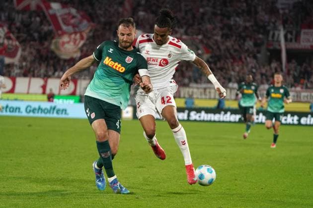 Football, 2 BL Season 2024 2025, 1 FC Köln SSV Jahn Regensburg 03 05 2025, Rheinenergie Köln Florian Ballas, SSV Regensburg damion downs FC Köln, action, single image