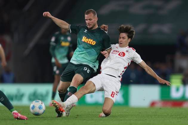 Eric Hottmann SSV Jahn Regensburg and Denis Huseinbasic 1 FC Koeln battle for the ball during the 2 Bundesliga match between 1 FC Köln and Jahn Regensburg at RheinEnergieStadion on May 03, 2025 in Cologne, Germany, Germany Photo by Oliver Kaelke DeFodi Images Eric Hottmann SSV Jahn Regensburg and Denis Huseinbasic 1 FC Koeln battle for the ball during the 2 Bundesliga match between 1 FC Köln and Jahn Regensburg at RheinEnergieStadion on May 3, 2025 in Cologne, Germany Photo by Oliver Kaelke DeFodi Images DFB DFL REGULATIONS PROHIBIT ANY USE OF PHOTOGRAPHS AS IMAGE SEQUENCES AND OR QUASI VIDEO Photo by Oliver Kaelke DeFodi Images