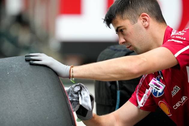 A crew member with Team Ferrari works with tires  Copyright: xScottxColeman IPAxSportx xipa-agency.netx xx IPA_57251417 IPA_Agency_IPA57251417